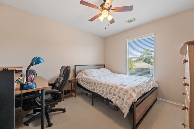 bedroom featuring light colored carpet, visible vents, baseboards, and ceiling fan