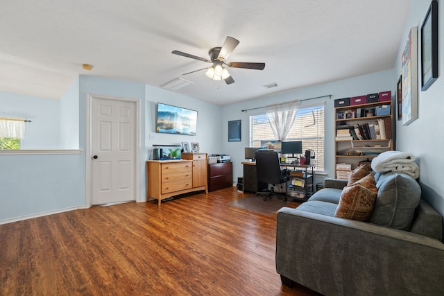 office featuring baseboards, dark wood-type flooring, a ceiling fan, and visible vents