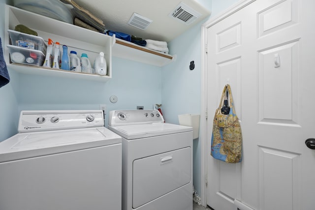 laundry room featuring washer and clothes dryer, laundry area, and visible vents