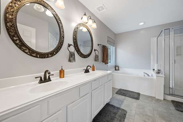 full bathroom featuring a garden tub, visible vents, a sink, and double vanity