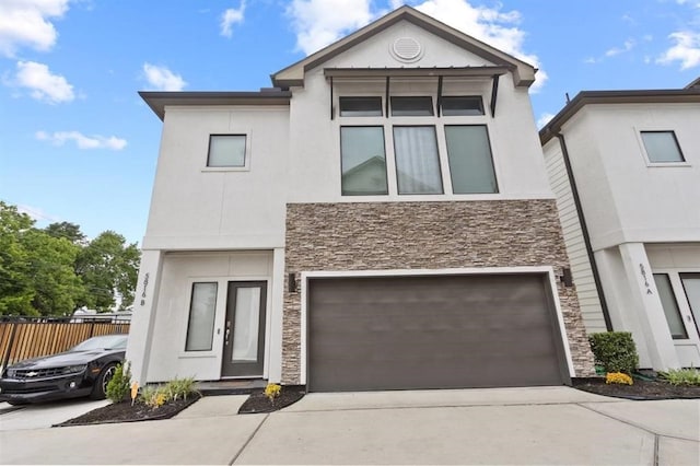 view of front of property featuring driveway, stone siding, and stucco siding