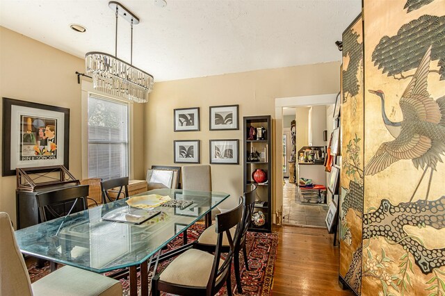 528 Hawthorne St, Houston, TX 77006 - dining space featuring hardwood / wood-style floors and a chandelier