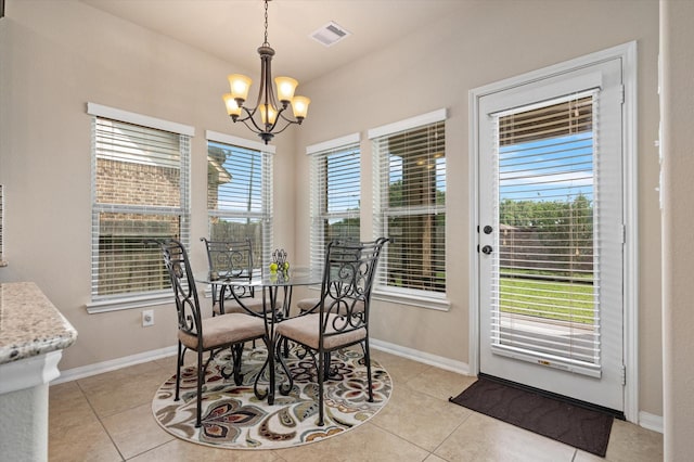 dining area with light tile patterned floors, a chandelier, visible vents, and baseboards
