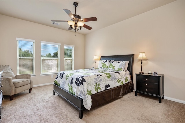 carpeted bedroom featuring visible vents, ceiling fan, and baseboards