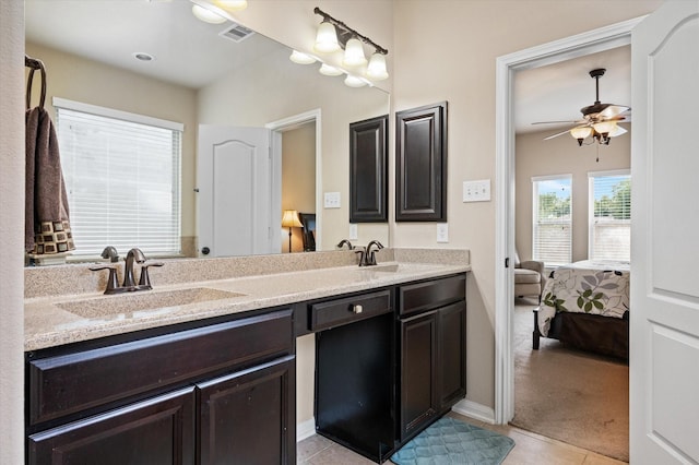 full bath with visible vents, connected bathroom, double vanity, and a sink