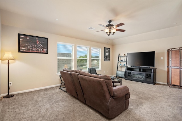 living area with a ceiling fan, carpet flooring, and baseboards