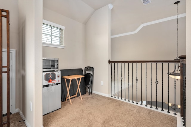 carpeted office space with lofted ceiling, visible vents, and baseboards