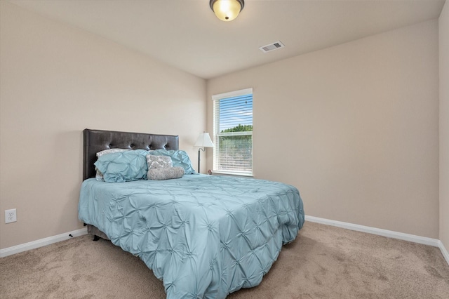 bedroom featuring visible vents, carpet flooring, and baseboards