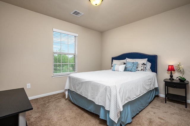 bedroom featuring visible vents, carpet floors, and multiple windows