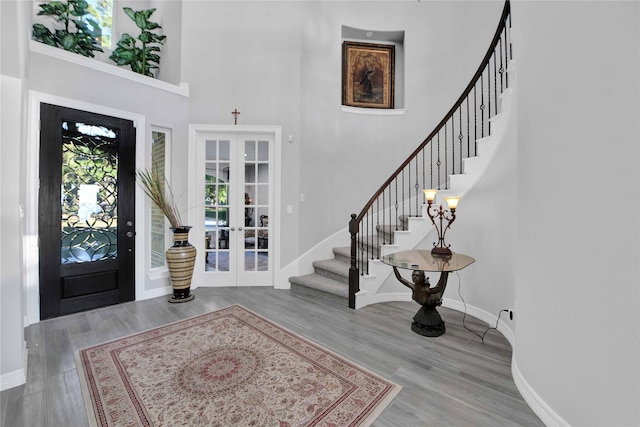 461 Pine Forest Acres Dr, Trinity, TX 75862 - entryway featuring a towering ceiling, french doors, stairs, and baseboards