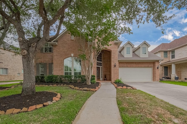 traditional-style house featuring driveway, a front yard, brick siding, and a garage