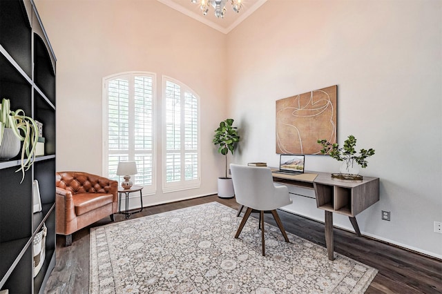 office space with dark wood finished floors, ornamental molding, a wealth of natural light, and a notable chandelier