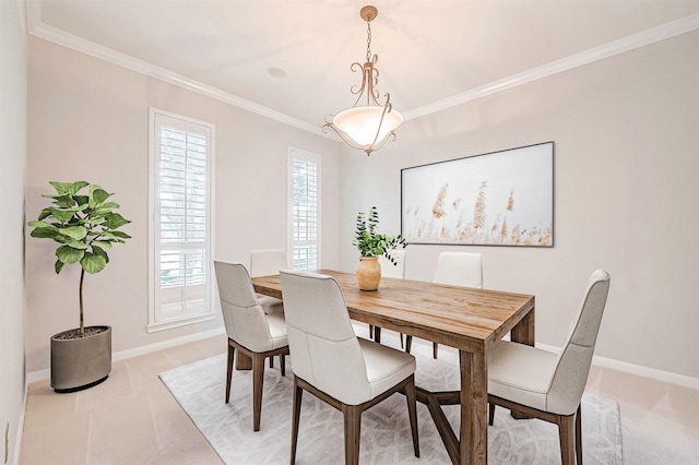 dining space featuring light colored carpet, crown molding, and baseboards