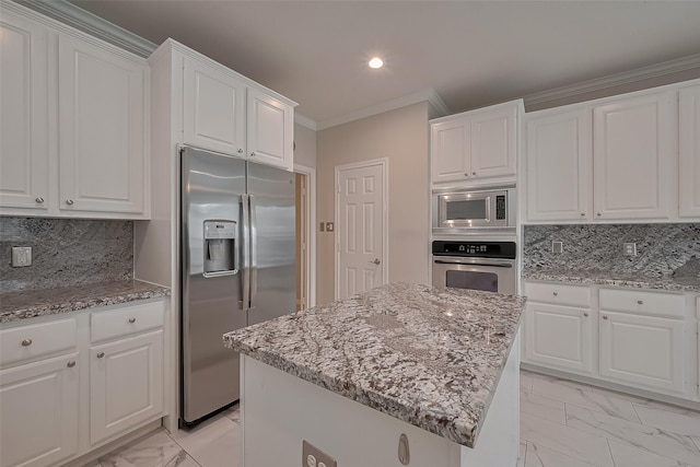 kitchen featuring crown molding, marble finish floor, white cabinets, and stainless steel appliances