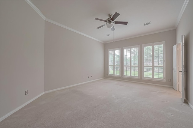 empty room with baseboards, ornamental molding, and light colored carpet