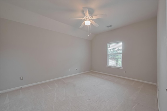 spare room featuring baseboards, visible vents, ceiling fan, and light colored carpet