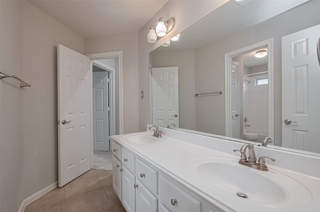full bathroom with toilet, tile patterned flooring, double vanity, and a sink