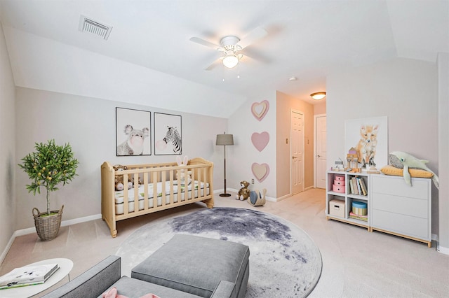 bedroom featuring baseboards, visible vents, light carpet, and lofted ceiling