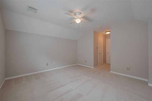 additional living space featuring lofted ceiling, visible vents, a ceiling fan, and light carpet