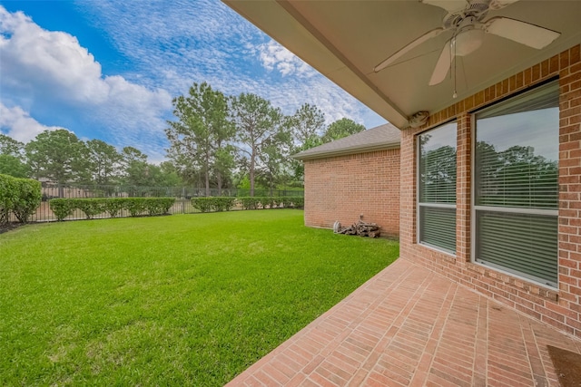view of yard featuring a patio, a ceiling fan, and fence