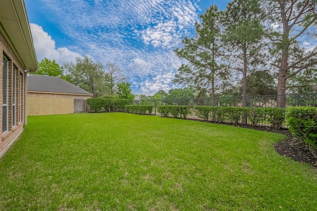 view of yard with a fenced backyard