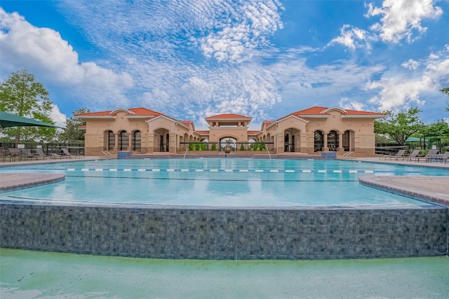 pool featuring a patio and fence