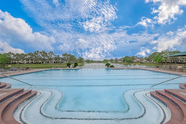 community pool with fence and a patio area