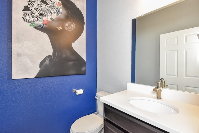 half bathroom with toilet and vanity