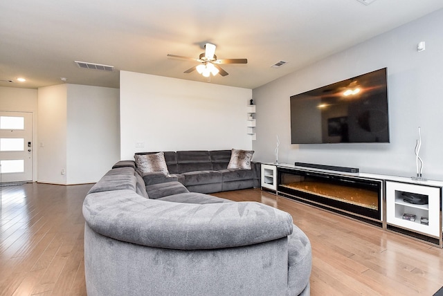 living room with visible vents, a ceiling fan, light wood-style flooring, and recessed lighting