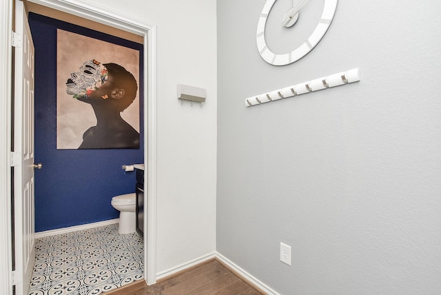 bathroom featuring toilet and baseboards