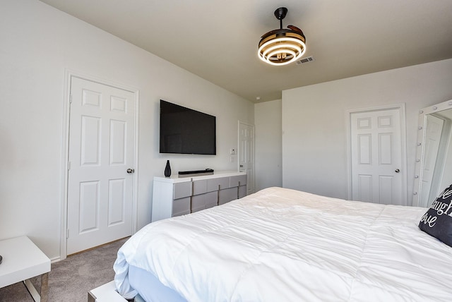 carpeted bedroom featuring visible vents