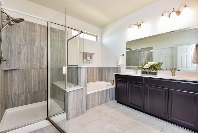 full bath with a stall shower, double vanity, a bath, and a sink