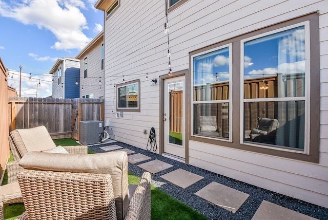 exterior space featuring fence and central air condition unit