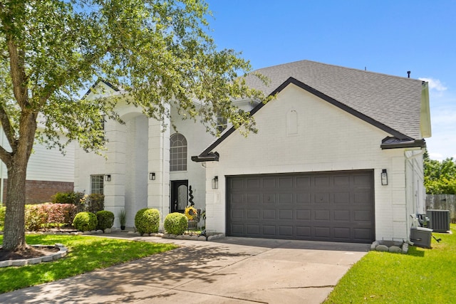 3631 Belmont Shore Ln, Missouri City, TX 77459 - french country inspired facade featuring brick siding, central AC, concrete driveway, and an attached garage