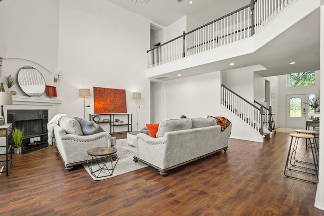 3631 Belmont Shore Ln, Missouri City, TX 77459 - living area with a high ceiling, stairs, wood finished floors, and a tile fireplace