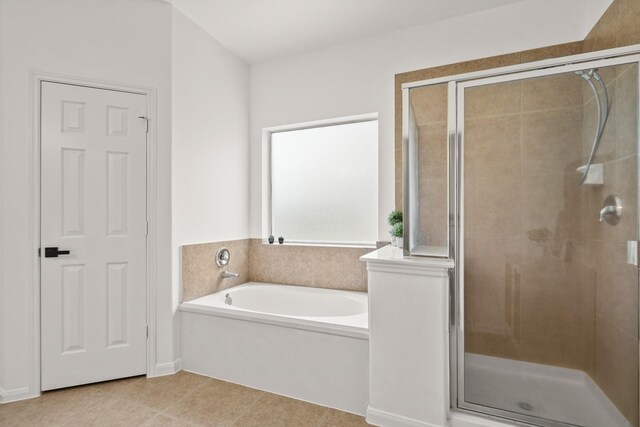 3631 Belmont Shore Ln, Missouri City, TX 77459 - bathroom featuring a stall shower, a bath, and tile patterned flooring