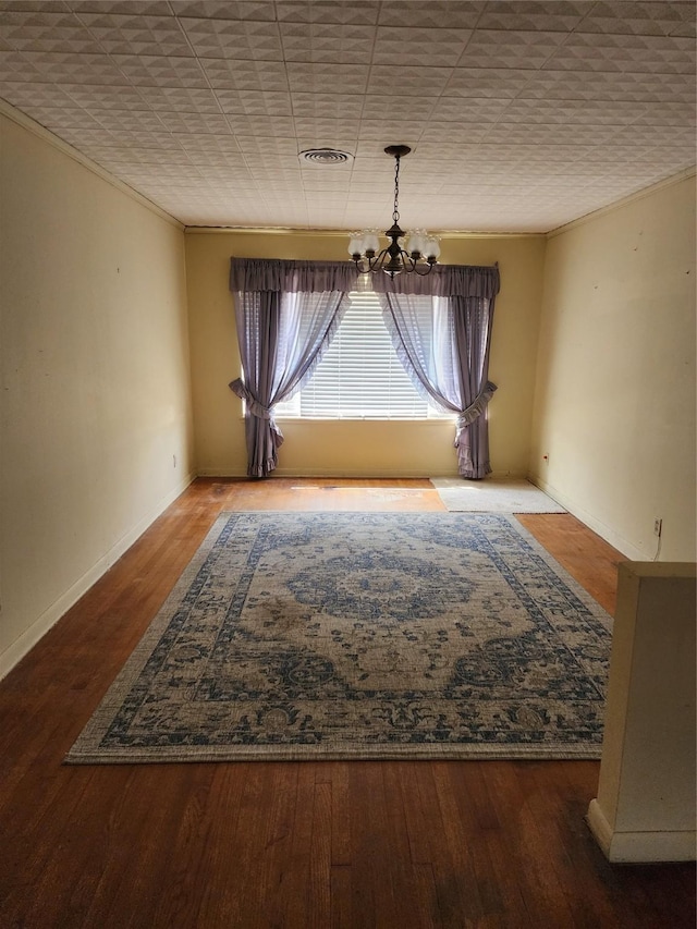 918 Redondo Dr, Houston, TX 77015 - unfurnished dining area with a chandelier, wood finished floors, baseboards, and crown molding