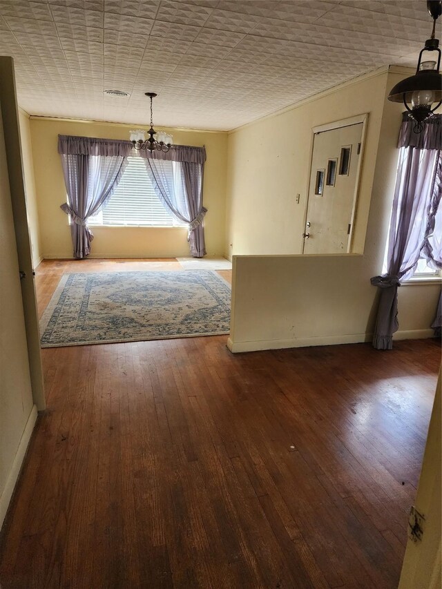 918 Redondo Dr, Houston, TX 77015 - unfurnished dining area featuring a chandelier, baseboards, and hardwood / wood-style floors