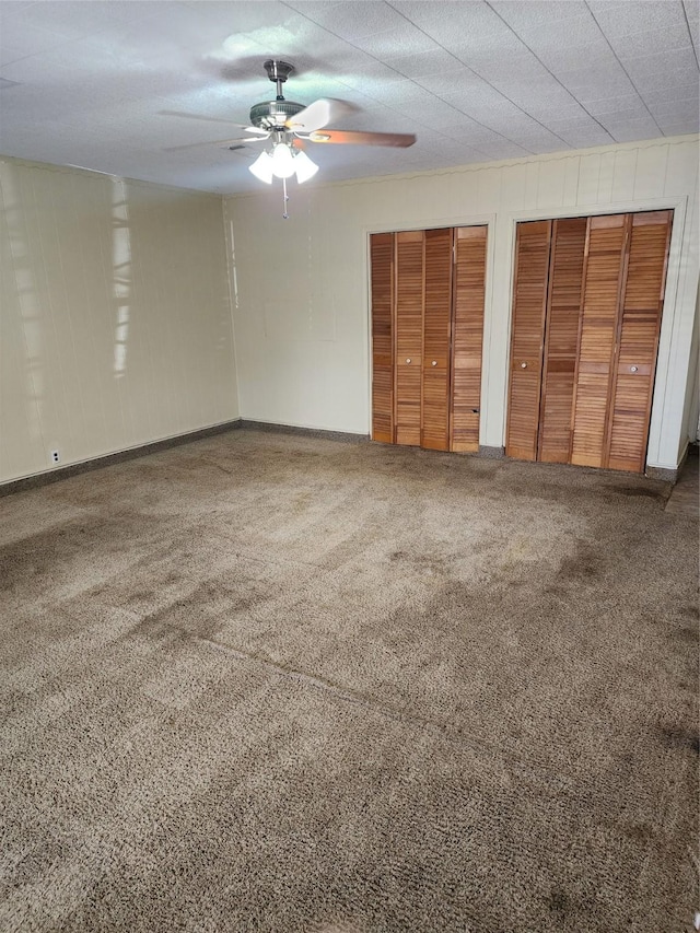 918 Redondo Dr, Houston, TX 77015 - unfurnished bedroom with two closets, carpet floors, ceiling fan, and baseboards