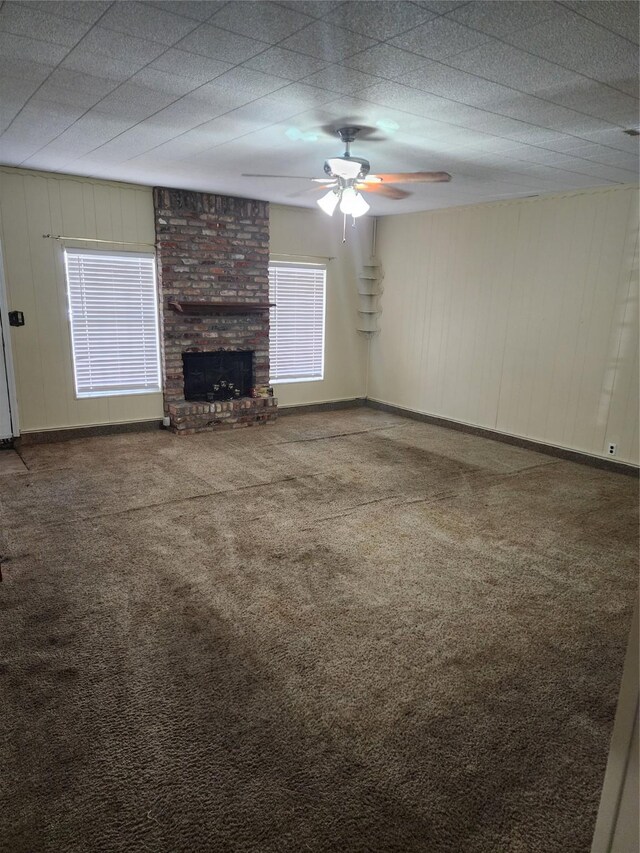 918 Redondo Dr, Houston, TX 77015 - unfurnished living room with carpet flooring, a ceiling fan, a fireplace, and baseboards