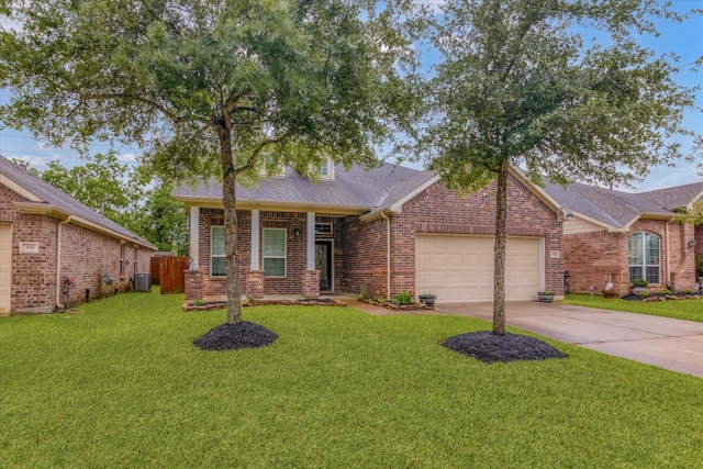 ranch-style house featuring a front lawn, a garage, driveway, brick siding, and fence