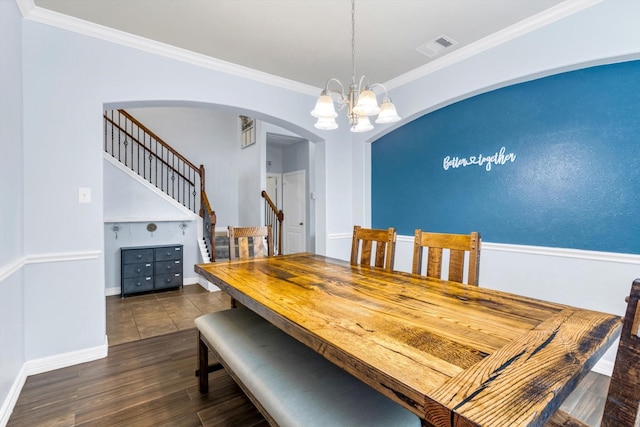 dining area featuring stairway, visible vents, a chandelier, arched walkways, and dark wood finished floors
