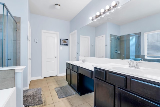 bathroom with a stall shower, tile patterned flooring, double vanity, and a sink