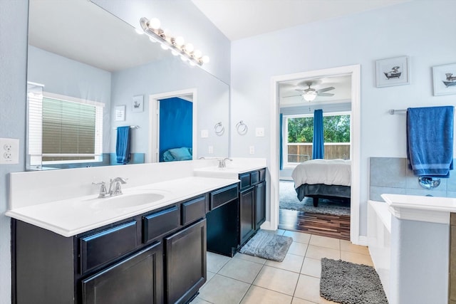 full bathroom with connected bathroom, a sink, double vanity, a ceiling fan, and tile patterned flooring