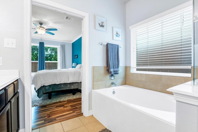 bathroom with connected bathroom, a bath, tile patterned floors, a ceiling fan, and visible vents