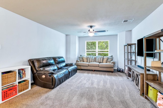 living room with visible vents, a ceiling fan, and carpet floors