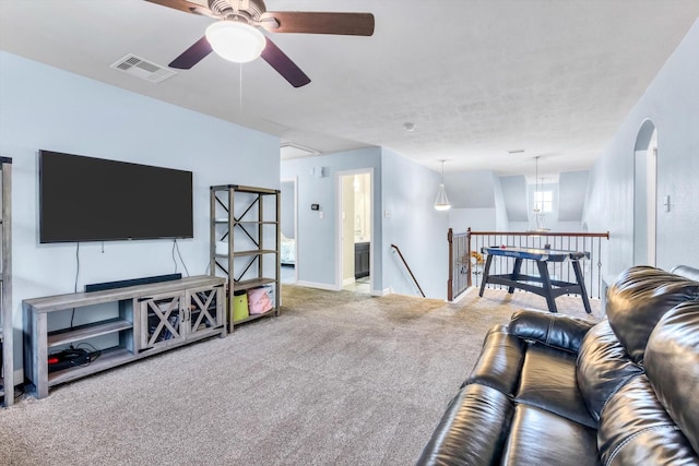 living area with visible vents, ceiling fan, carpet floors, and baseboards
