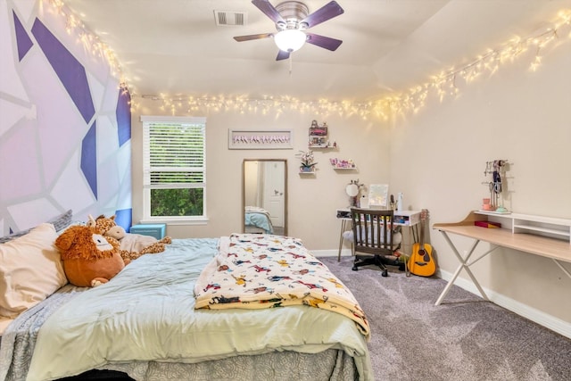 carpeted bedroom with baseboards, visible vents, and a ceiling fan