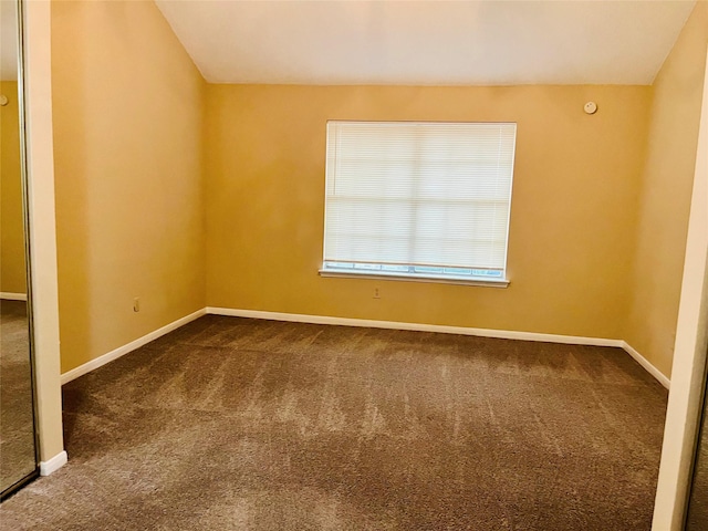 2910 Grants Lake Blvd Unit 1603, Sugar Land, TX 77479 - empty room featuring dark colored carpet, lofted ceiling, and baseboards