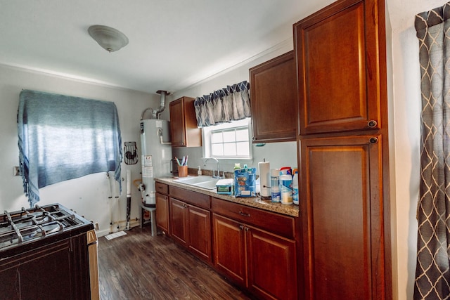 5514 Pardee St, Houston, TX 77026 - kitchen with a sink, gas water heater, light countertops, dark wood finished floors, and gas range